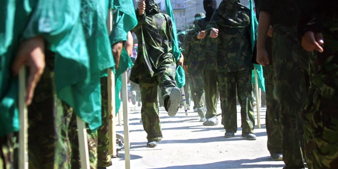 Masked members of Hamas hold Islamic flags during a 2002 march in the Jabalia refugee camp in the Gaza Strip to protest against the U.S. position on Jerusalem. Abid Katib/Getty Images