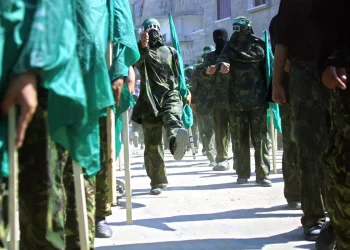Masked members of Hamas hold Islamic flags during a 2002 march in the Jabalia refugee camp in the Gaza Strip to protest against the U.S. position on Jerusalem. Abid Katib/Getty Images